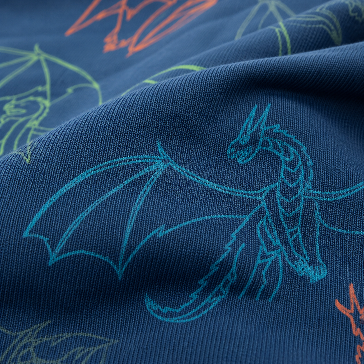 French terry estampado dragones fondo azul — imagen 1